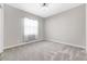 Bedroom with neutral walls, plush carpet and a large window with natural light at 11726 Sunburst Marble Rd, Riverview, FL 33579