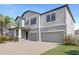 Attractive home featuring a three-car garage, manicured lawn, and a welcoming front entrance at 11726 Sunburst Marble Rd, Riverview, FL 33579