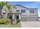 Beautiful two-story home featuring a three-car garage, landscaped yard, and a welcoming front porch at 11726 Sunburst Marble Rd, Riverview, FL 33579