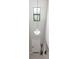 Bright foyer featuring tile floors, a stylish pendant light, and a front door with sidelight window at 11726 Sunburst Marble Rd, Riverview, FL 33579