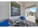 Cozy front porch seating area with modern chairs, patterned rug, and view of the home's exterior at 11726 Sunburst Marble Rd, Riverview, FL 33579