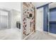 Hallway with geometric accent wall leading to bathroom and a walk-in closet at 11726 Sunburst Marble Rd, Riverview, FL 33579