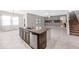 Open concept kitchen with center island, stainless steel appliances and abundant natural light at 11726 Sunburst Marble Rd, Riverview, FL 33579