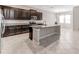 Spacious kitchen features dark cabinets, granite countertops, stainless steel appliances, and a large island at 11726 Sunburst Marble Rd, Riverview, FL 33579