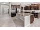Spacious kitchen features dark cabinets, granite counters, a large island, and stainless steel appliances at 11726 Sunburst Marble Rd, Riverview, FL 33579