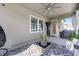 Covered lanai featuring a ceiling fan, decorative plants, and views of the backyard at 11726 Sunburst Marble Rd, Riverview, FL 33579