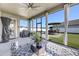Screened in lanai with views of an outdoor kitchen and landscaped backyard at 11726 Sunburst Marble Rd, Riverview, FL 33579