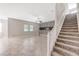 Spacious living room with tile flooring, staircase, and modern decor at 11726 Sunburst Marble Rd, Riverview, FL 33579