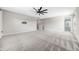 Large living room with plush carpet, ceiling fan and tv mount at 11726 Sunburst Marble Rd, Riverview, FL 33579