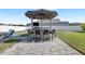 Backyard featuring a stone paved area with outdoor bar, seating, and sunshade at 11726 Sunburst Marble Rd, Riverview, FL 33579