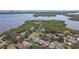 Aerial view displays waterfront community nestled among lush greenery, lakes, and water access at 1175 San Carlos Ne Ave, St Petersburg, FL 33702