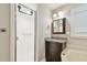 Cozy bathroom featuring a shower, dark vanity, granite countertop, framed mirror, and modern lighting at 1175 San Carlos Ne Ave, St Petersburg, FL 33702