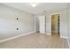 Bedroom with wood-look floors, neutral walls, white trim, and walk-in closet at 1175 San Carlos Ne Ave, St Petersburg, FL 33702
