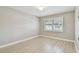 Bright bedroom featuring wood-look floors, a window with shutters, neutral walls, and white trim at 1175 San Carlos Ne Ave, St Petersburg, FL 33702