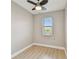 This quaint bedroom features wood flooring, fresh neutral paint, and natural light from a large window with blinds at 1175 San Carlos Ne Ave, St Petersburg, FL 33702
