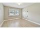 Well-lit bedroom with wood-look floors, window with shutters, and neutral paint at 1175 San Carlos Ne Ave, St Petersburg, FL 33702