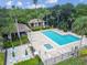 Inviting community pool and spa surrounded by lush landscaping and lounge seating at 1175 San Carlos Ne Ave, St Petersburg, FL 33702