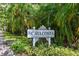 The Isle of Cayacosta community sign surrounded by lush tropical foliage at 1175 San Carlos Ne Ave, St Petersburg, FL 33702