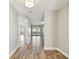 Bright hallway featuring wood-look flooring and views of a sunlit living area with access to the backyard at 1175 San Carlos Ne Ave, St Petersburg, FL 33702