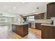 Updated kitchen featuring stainless appliances, dark cabinets, an island and an adjacent dining area for modern living at 1175 San Carlos Ne Ave, St Petersburg, FL 33702