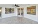 A screened lanai showcases tile flooring and double doors leading to the outdoor space at 1175 San Carlos Ne Ave, St Petersburg, FL 33702