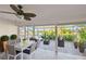 Screened in lanai with patio furniture and a serene water view at 1175 San Carlos Ne Ave, St Petersburg, FL 33702