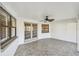Spacious screened lanai featuring tile flooring, windows, and a ceiling fan for comfortable outdoor living at 1175 San Carlos Ne Ave, St Petersburg, FL 33702