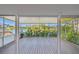 Covered lanai with wood flooring and views of the beautiful lake and surrounding landscape at 1175 San Carlos Ne Ave, St Petersburg, FL 33702
