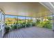 The covered lanai offers peaceful views of the lake, mature landscaping, and other nearby homes at 1175 San Carlos Ne Ave, St Petersburg, FL 33702