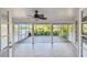 Enclosed lanai offering tile and wood flooring with expansive views of the surrounding pond and greenery at 1175 San Carlos Ne Ave, St Petersburg, FL 33702
