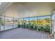 Covered lanai with wood flooring and screened views of the sparkling lake at 1175 San Carlos Ne Ave, St Petersburg, FL 33702