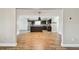 Open concept kitchen with stainless steel appliances, dark cabinetry, an island and views into the living area at 1175 San Carlos Ne Ave, St Petersburg, FL 33702
