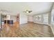 Spacious living room with wood-look floors, neutral walls, and a ceiling fan for comfortable living at 1175 San Carlos Ne Ave, St Petersburg, FL 33702
