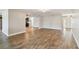 Open-concept living space with wood-look floors, access to other living areas, and neutral-colored walls at 1175 San Carlos Ne Ave, St Petersburg, FL 33702