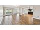 Spacious living room with wood-look flooring, open access to other rooms, and a bright airy atmosphere at 1175 San Carlos Ne Ave, St Petersburg, FL 33702