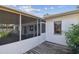 Spacious screened in porch features a full view of the exterior and wooden deck with white stucco home at 1175 San Carlos Ne Ave, St Petersburg, FL 33702