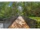 Scenic wooden walkway amidst lush greenery creating a peaceful path at 1175 San Carlos Ne Ave, St Petersburg, FL 33702