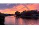 Scenic water view at sunset, with a tree-lined bank in the foreground and colorful sky reflected on the water at 1175 San Carlos Ne Ave, St Petersburg, FL 33702