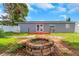 Cozy backyard space with a fire pit and a charming deck, perfect for outdoor entertaining at 11809 129Th Ave, Largo, FL 33778