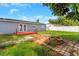 Spacious backyard featuring a fire pit, brick accents, and a cozy deck area at 11809 129Th Ave, Largo, FL 33778