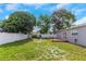 Lush backyard with mature trees, a fire pit, and a storage shed for outdoor equipment at 11809 129Th Ave, Largo, FL 33778
