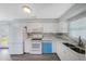 Well-lit kitchen with white cabinetry, quartz countertops, and new stainless steel appliances at 11809 129Th Ave, Largo, FL 33778