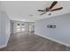 Bright living room with modern flooring, a ceiling fan, and access to the backyard at 11809 129Th Ave, Largo, FL 33778