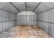 An empty metal shed with a concrete tile floor at 11809 129Th Ave, Largo, FL 33778