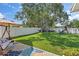 Landscaped backyard with a swing set and mature tree providing plenty of shade at 11927 Steppingstone Blvd, Tampa, FL 33635