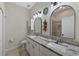 Bathroom featuring double sinks, granite countertops and decorative mirrors at 11927 Steppingstone Blvd, Tampa, FL 33635