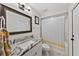 Bathroom features a stylish granite countertop, framed mirror, and shower with tub at 11927 Steppingstone Blvd, Tampa, FL 33635