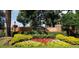 Landscaped community entrance with colorful flowerbeds, brick pillars, and signage at 11927 Steppingstone Blvd, Tampa, FL 33635
