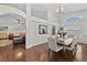 Bright dining area with white walls, wood floors, and a view into the living room at 11927 Steppingstone Blvd, Tampa, FL 33635