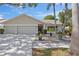 Charming single-story home with a well-manicured lawn and a three-car garage at 11927 Steppingstone Blvd, Tampa, FL 33635